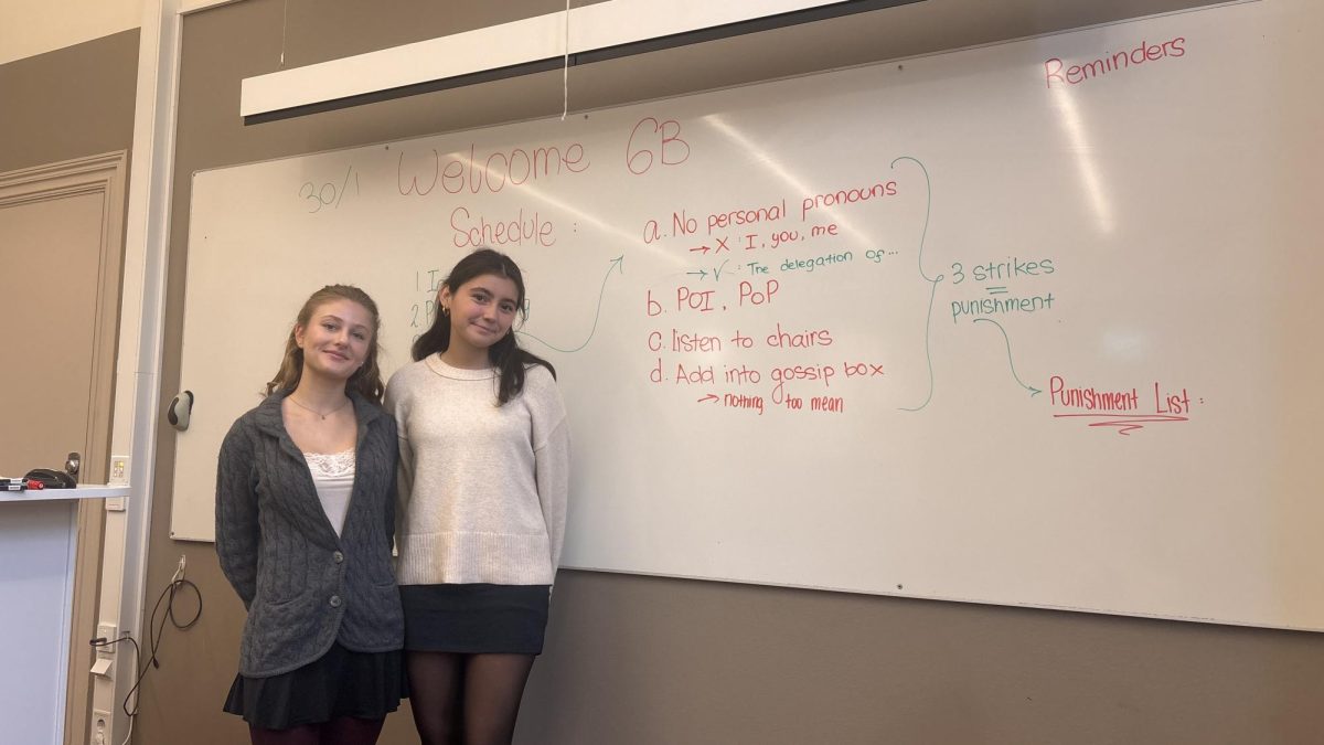 Victoria M. and Annika O. preparing the classroom for 6B